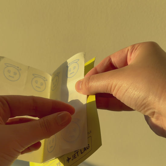 hands opening a pouch on a cream background
